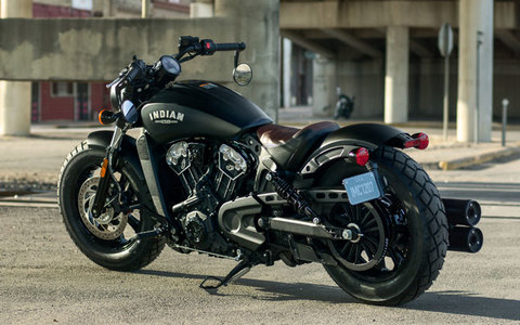 2017 Indian Scout Motorcycle Burgundy Black parked in front of abandoned cement building